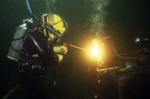 Home 248 A commercial diver cutting through metal